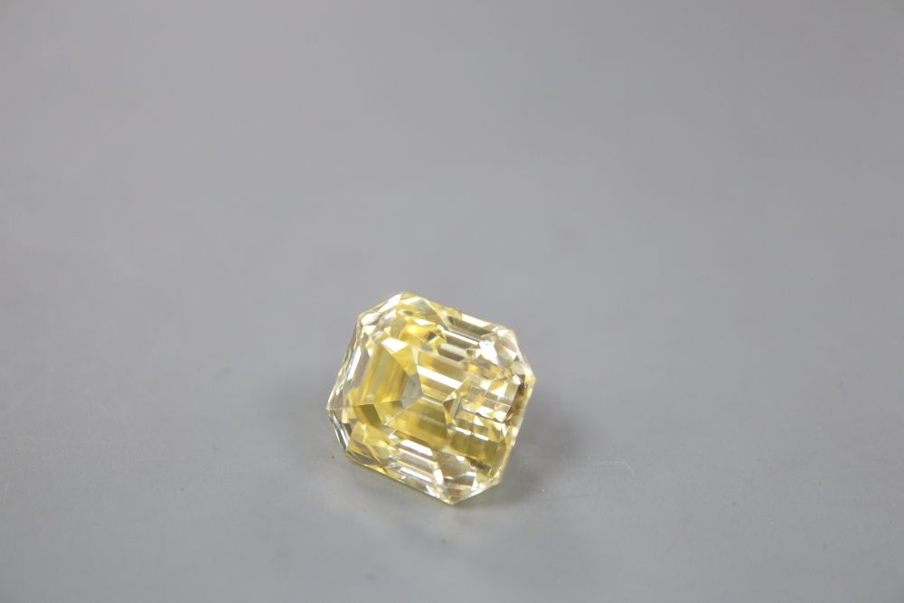 An unmounted emerald cut yellow gemstone, possibly cubic zirconia, weighing approximately 29.00ct.